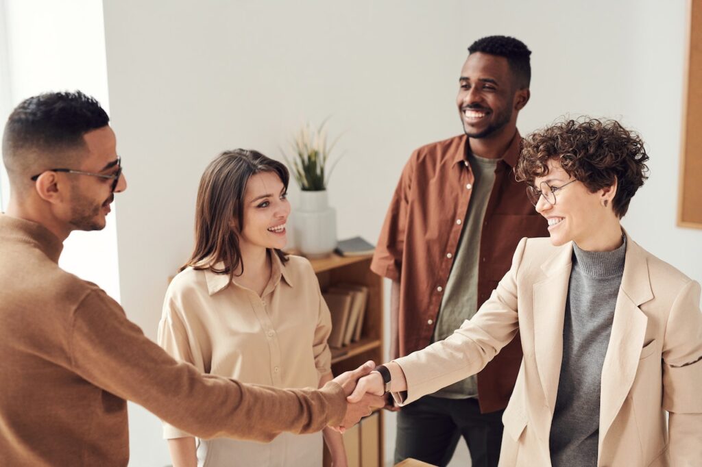 confident woman shaking hands with colleague